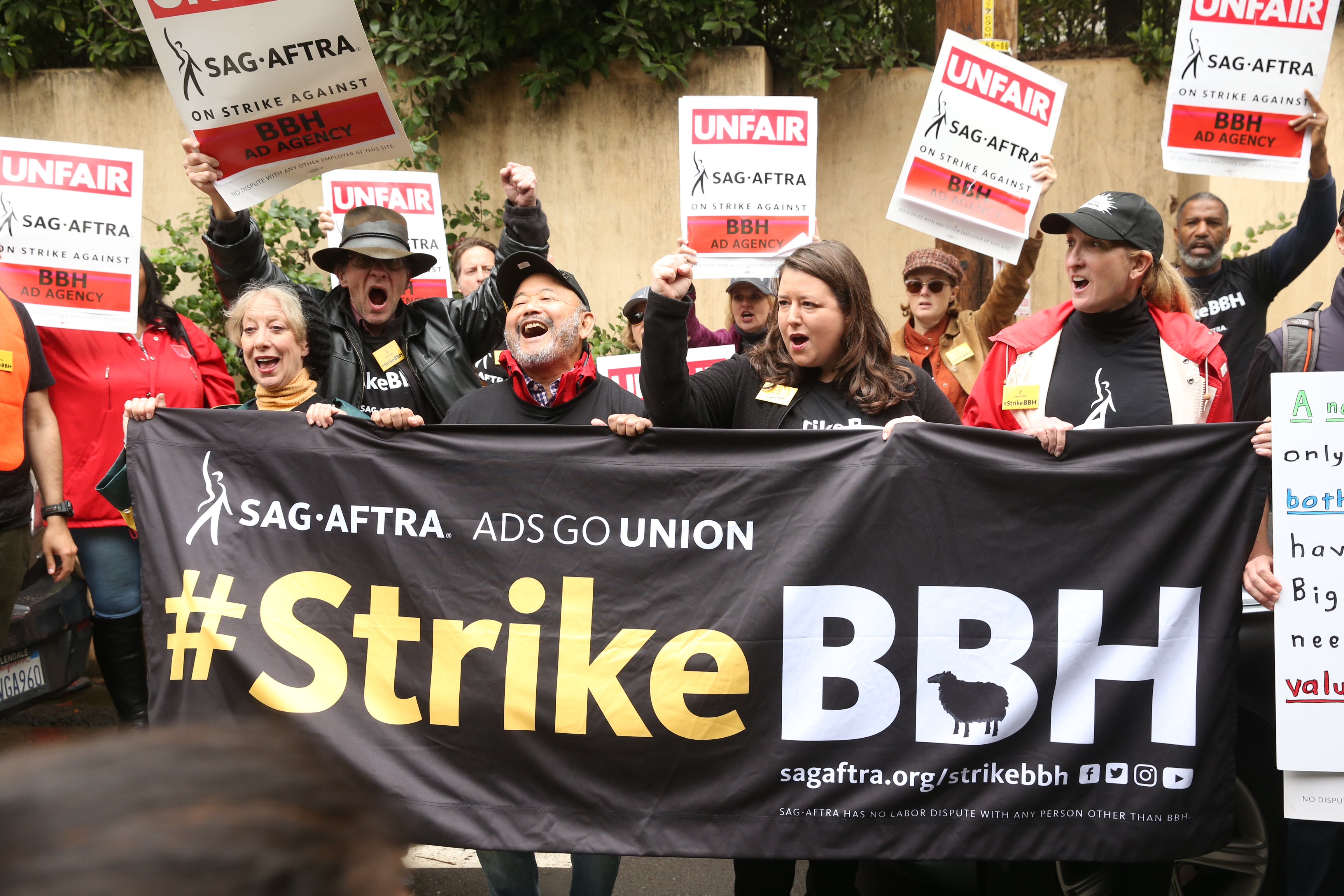 Members holding a banner 