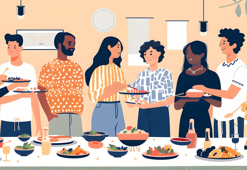 Diverse group of people standing in front of a table full of food