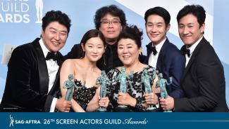 "Parasite" cast holding their Actor backstage in the Media Room
