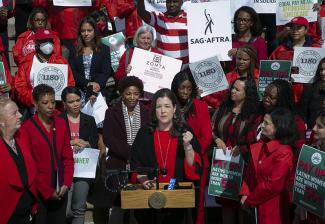 N.Y. Local Executive Director Rebecca Damon speaks on the steps of City Hall. Photo courtesy of William Alatriste