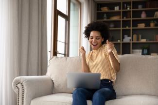 Excited SAG-AFTRA member on her laptop.