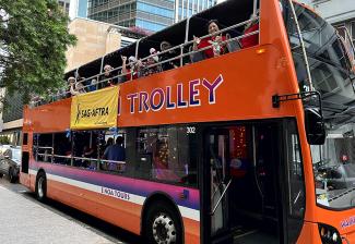 Members ride the Waikiki Trolley