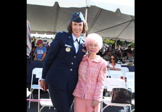 Dewan-Smith, in uniform, stands in the sun with Goldberg.