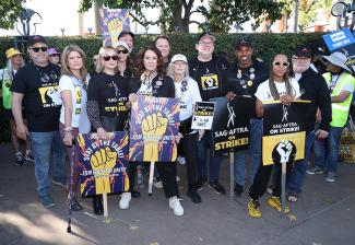 The SAG-AFTRA Negotiating Committee, National Executive Director and Chief Negotiator Duncan Crabtree-Ireland, and SAG-AFTRA member Kerry Washington walk the picket line at Disney Studios for the unity picket. 