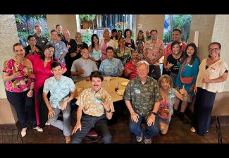 A photo of a large, diverse crowd inside a restaurant area.