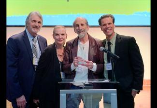 McLauglin-Zimet Union Spirit Award recipient Steve Gladstone, center, flanked by award presenters Dave Corey, National Board member Nancy Duerr, and Miami Local President John McKarthy.  