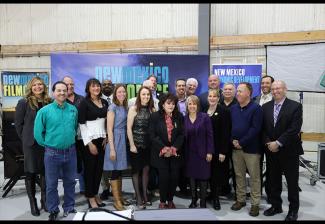 New Mexico Gov. Michelle Lujan Grisham, fourth from right, front row, is joined by industry stakeholders at the signing of SB 2 into law.