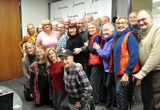 After a chorus of Happy Trails, the Seniors Committee and Czernecki (in pink) gather for a group goodbye hug.