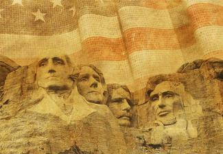 Image of Mount Rushmore in a sepia tone with the American flag behind it.