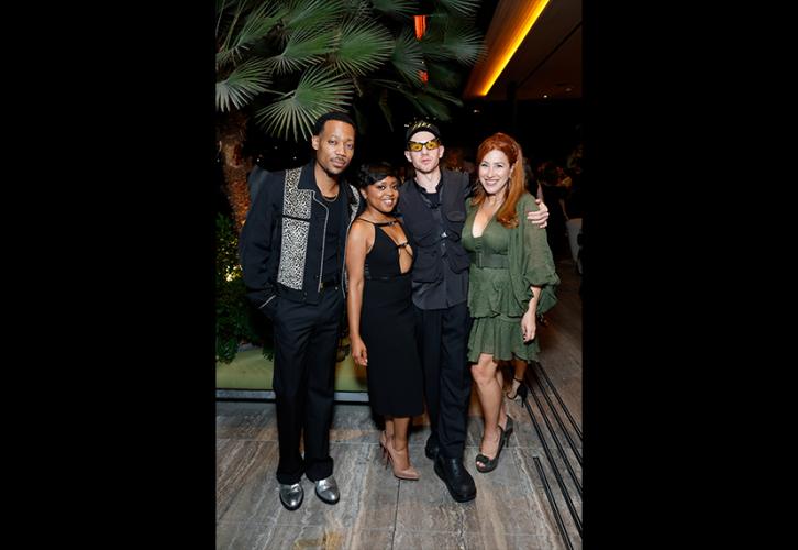 From left, Williams, Brunson, Perfetti and Walter stand closely together. Williams wears a distinctive black jacket with silver detail; Brunson, a black dress; Perfetti, a gray utility jacket with orange-lensed sunglasses and hat; and Walter, a green dress with ruffles. Behind them is a palm tree.