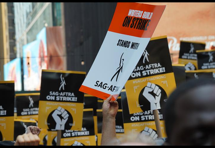 A supporter raises a WGA sign.