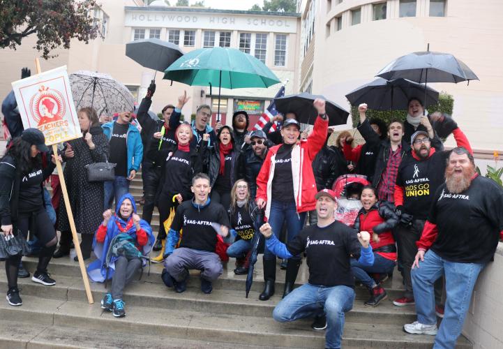 Members gathered on the steps with their fists in the air