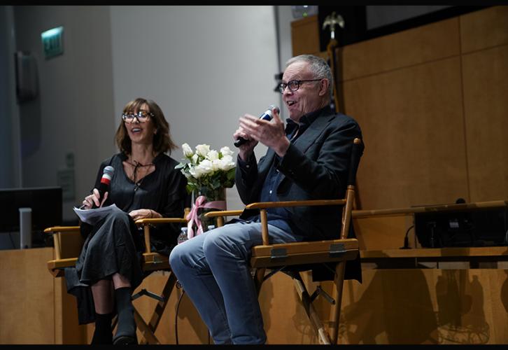 Merle Gingsberg with Neal Baer seated with microphones at the SAG-AFTRA Plaza. 
