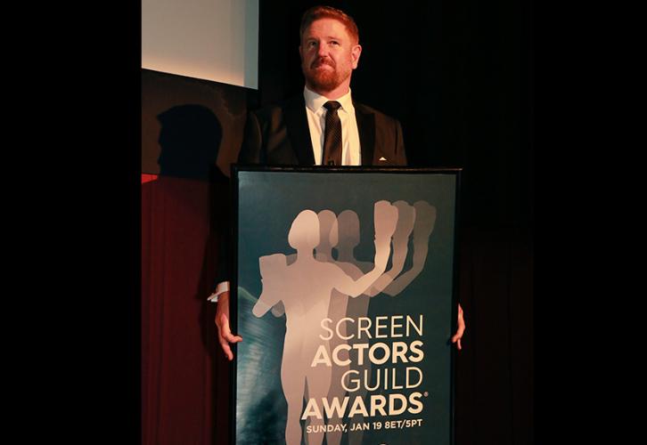 SAG Awards Viewing Party Committee Co-Chair DJ Morrison holds up this year’s poster with a majestic twinkle in his eye. Photo by SuperCybers