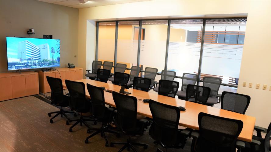 Conference Room with a large table in the middle and chairs all around.