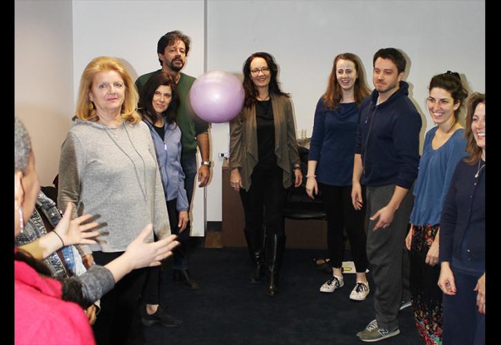 New England Local members stand in a circle as a purple ball is thrown in the air.