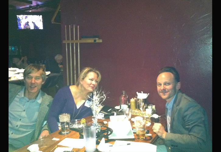 Colorado Local members and invited industry guests at a table with drinks and food.. 