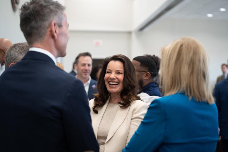 SAG-AFTRA President Fran Drescher smiling while talking to a man and a woman.