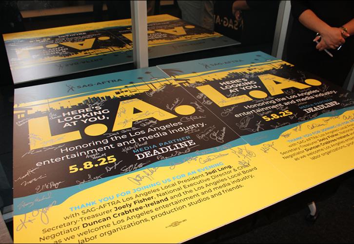 An image of two event posters with various signatures. 