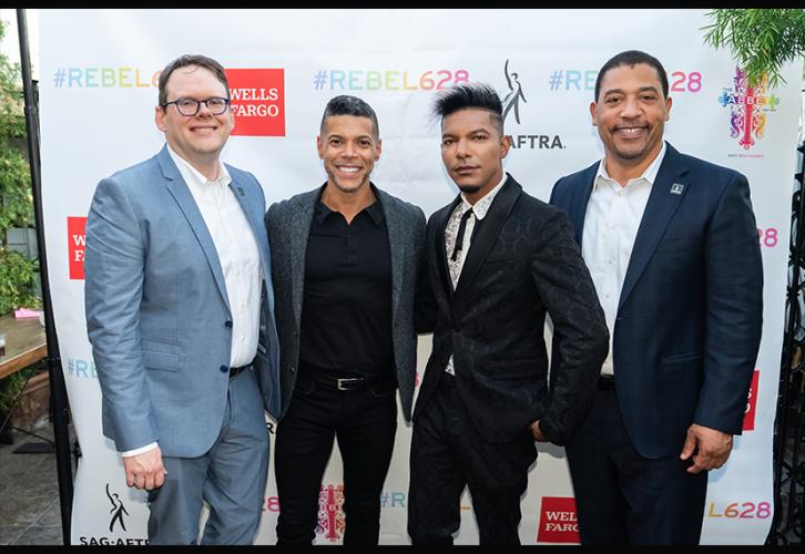 From left, Crabtree-Ireland, SAG-AFTRA members Wilson Cruz and Stevie Mackey, and White behind backdrop.