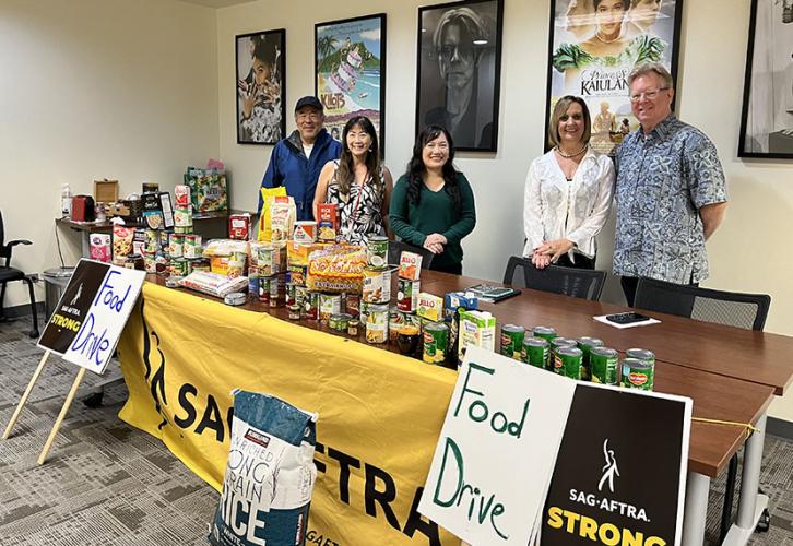 From left, Hawaii Local members Ed Chin, Jodie Yee, Grace Swartz, Jeannie Barber and Hawaii Local Secretary Scott Swartz sort food donations at the local office before a donation drop at the Hawaii Food Bank.
