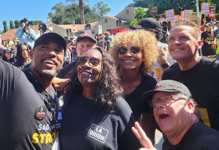 From left, Negotiating Committee members Jason George and Kevin E. West, L.A. Fed President Yvonne Wheeler, and Negotiating Committee members Michelle Hurd, Sean Astin and Woody Shultz take a selfie while attending the AFL-CIO rally on Aug. 22.