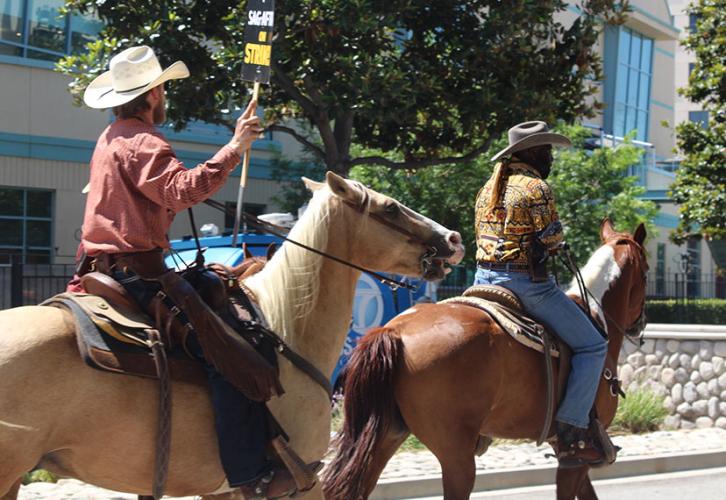 Horse owners in the Burbank area ride by Disney Studios in support of SAG-AFTRA on Aug. 22.