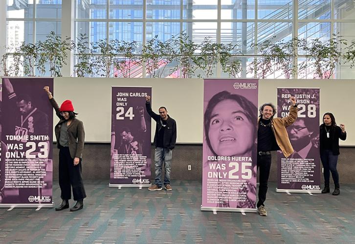 abanela, Singh, Belardinelli and Gupta stand next to banners.