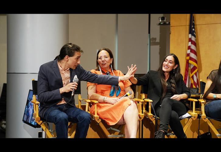 Tokala Black Elk, far left, and Q’orianka Kilcher give each other a high-five on the panel. 