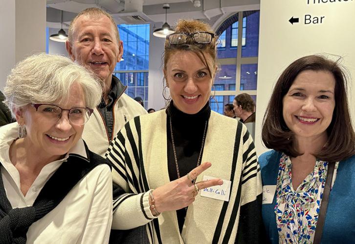 Beaulieu, Thorpe and DelliColli are dressed in black and white, and Proude wears a blue sweater over a multicolored top. DelliColli makes a V sign.