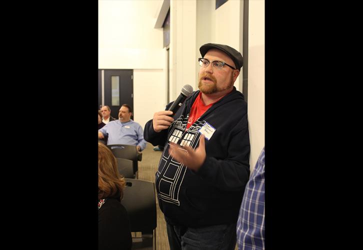Local member Dennis Mahler asks a question during Q&A.