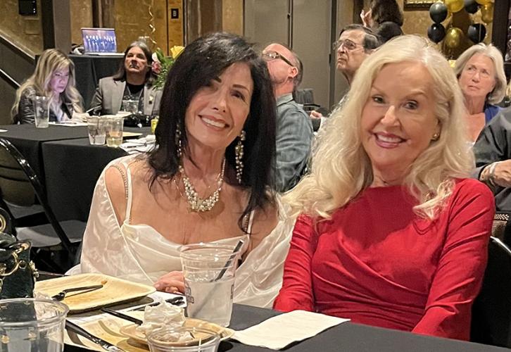 Rossi and Accetta smile as they sit at a table.