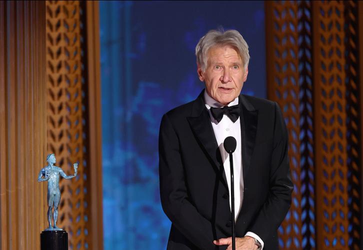 Harrison Ford is on stage. Beside him is the SAG Awards statuette. 