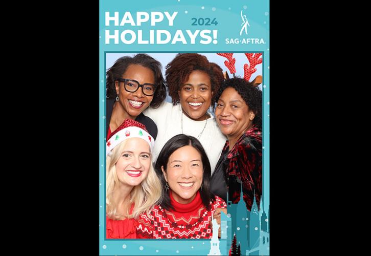 Five people in festive attire smile for a holiday photo. Around the edge of the photo is a blue digital frame that reads Happy Holidays! 2024 SAG-AFTRA.