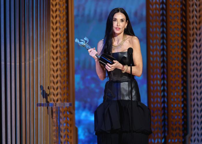 Demi Moore speaks from on stage. In her hands is the SAG Awards statuette.