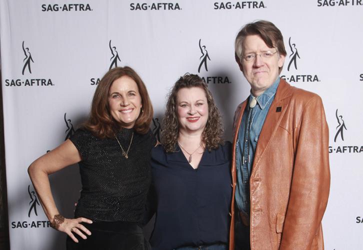 Three smiling people pose in front of a white SAG-AFTRA step-and-repeat banner.