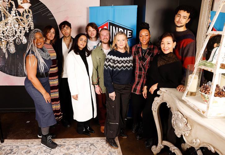 A diverse group of nine individuals in a restaurant setting.