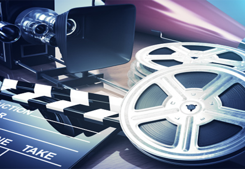 Lights, Camera, Action! A film clapper board sits to the left of two movie reels.