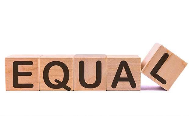 Image of wooden blocks spelling out 'Equality' with a white background.