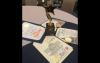 A statuette and four certificates are presented on a table. The statuette depicts a star suspended in the air with a comet-like tail. The certificates are stylishly placed flat on the table, fanning around the statuette.