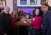 Four people gather around a table in a New York restaurant.