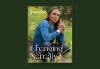 Cover art for "'Hero image for "'SAG-AFTRA' Fall/Winter 2022 Digital Issue is Now Available", star Zahn McClarnon, is crouched in a field with yellow flowers. A dark green border surrounds the image. Hero image for "'SAG-AFTRA' Fall/Winter 2022 Digital Issue is Now Available"