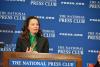SAG-AFTRA President Fran Drescher stands at a podium baring the National Press Club's emblem mid-speech. Hero Image of SAG-AFTRA President Fran Drescher at the National Press Club luncheon on April 25.