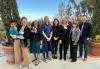 A photo of nine individuals, including one child, taken outdoors.