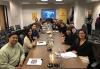 Cast of the inaugural SF-NC Local Conservatory Screenplay Reading Series pictured at the SAG-AFTRA Local office in downtown SF after reading Forbidden City, created by Michael Ching, right middle. Ben Fong-Torres, right middle with glasses, participated in the table read playing himself. Nineteen people sit on either side of a long conference table, while a few others stand behind them. On the wall is a large screen flanked by SAG-AFTRA banners.