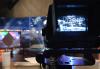 Camera with studio on opposite end recording
