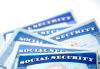 Don't add SSNs to Vouchers Pile of blue Social Security Cards fanned out