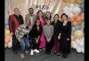 SAG-AFTRA members and staff join the L.A. Federation of Labor for its 2025 MLK Day Breakfast Celebration. A group of individuals pose in front of a peach backdrop with peach, pale yellow, pale blue and white balloons on both sides.