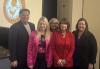 From left, New Jersey State AFL-CIO President Charles Wowkanech, SAG-AFTRA Philadelphia Local President Nicole Izanec, SAG-AFTRA National Board member & New York Local Vice President Liz Zazzi, New Jersey State AFL-CIO Secretary-Treasurer Laurel Brennan, and SAG-AFTRA Chief Labor Policy Officer & New York Local Executive Director Rebecca Damon. A diverse group of people stand in front of a beige wall. There is the New Jersey State AFL-CIO logo behind them and an American flag to the right.