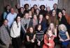 Twin Cities members and guests gather for the 31st Annual SAG Awards watch party at the Ballentine VFW hall in Uptown, Minneapolis. A group of approximately 30 smiling people, some standing some kneeling gather before a SAG-AFTRA step-and-repeat banner.